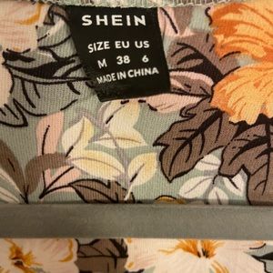 Floral pleated a line dress with long flare sleeves.